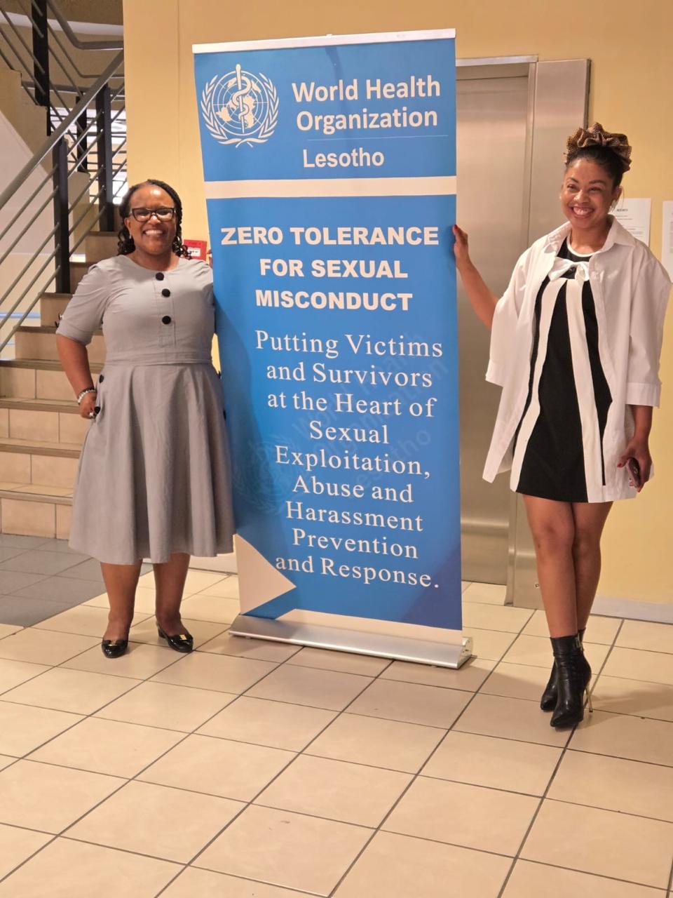 Policy development with WHO Lesotho beside the zero-tolerance banner